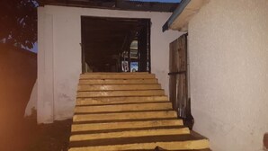 A set of wooden stairs leading to a building entrance. - Topway Hotel (Nkawkaw)