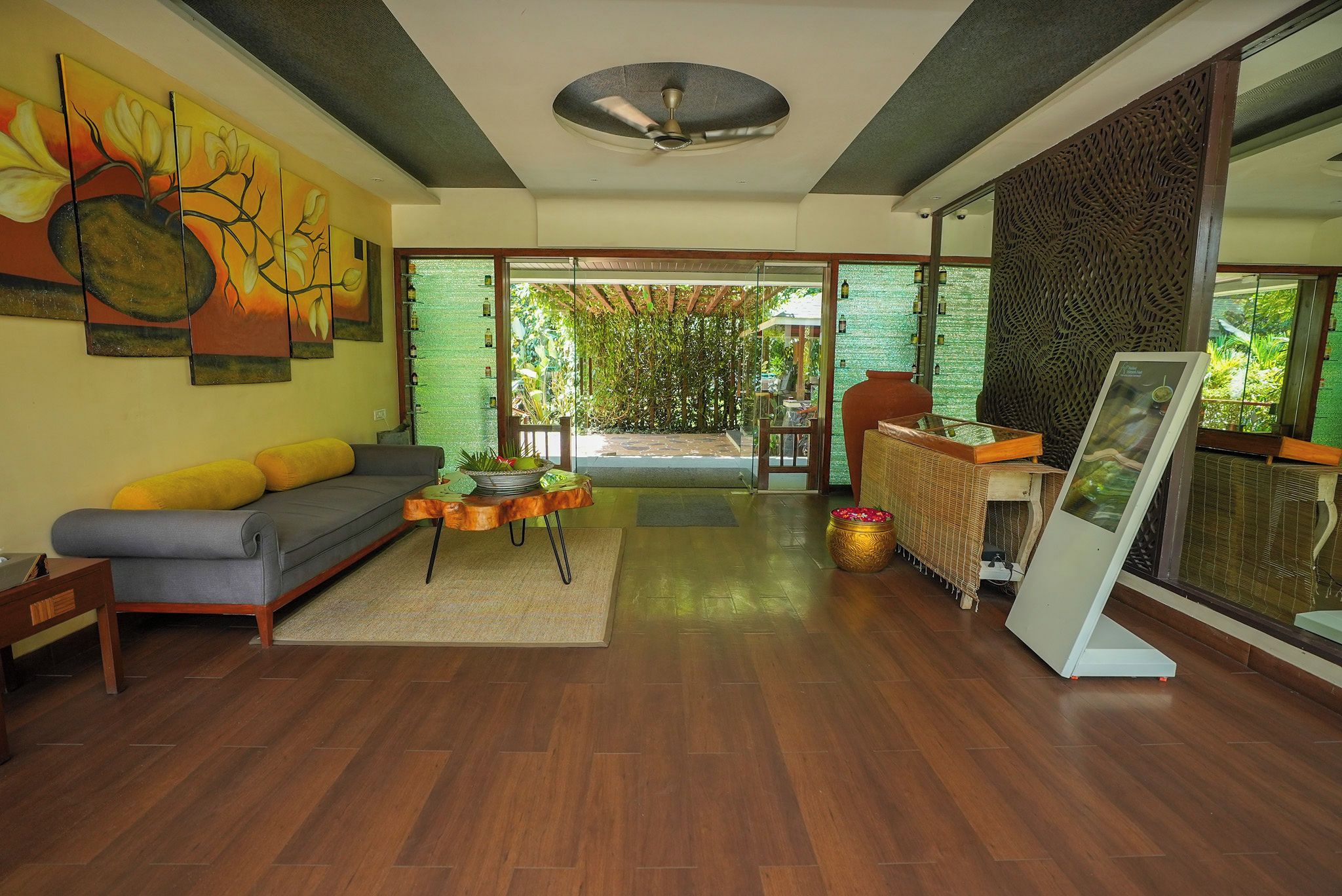 A modern living room with a sofa, coffee table, and artwork on the wall.