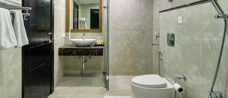 A modern bathroom with a bathtub, toilet, and sink.