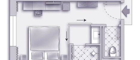 A floor plan of a hotel room with a large bed, a separate bathroom, and a small kitchenette.