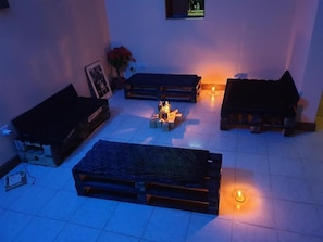 A room with a sofa set, a small table with candles, and a wall-mounted TV. - Jamhuri Home 2 (Nairobi)