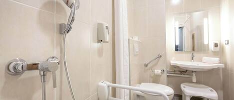 A modern bathroom with a shower, toilet, and sink.