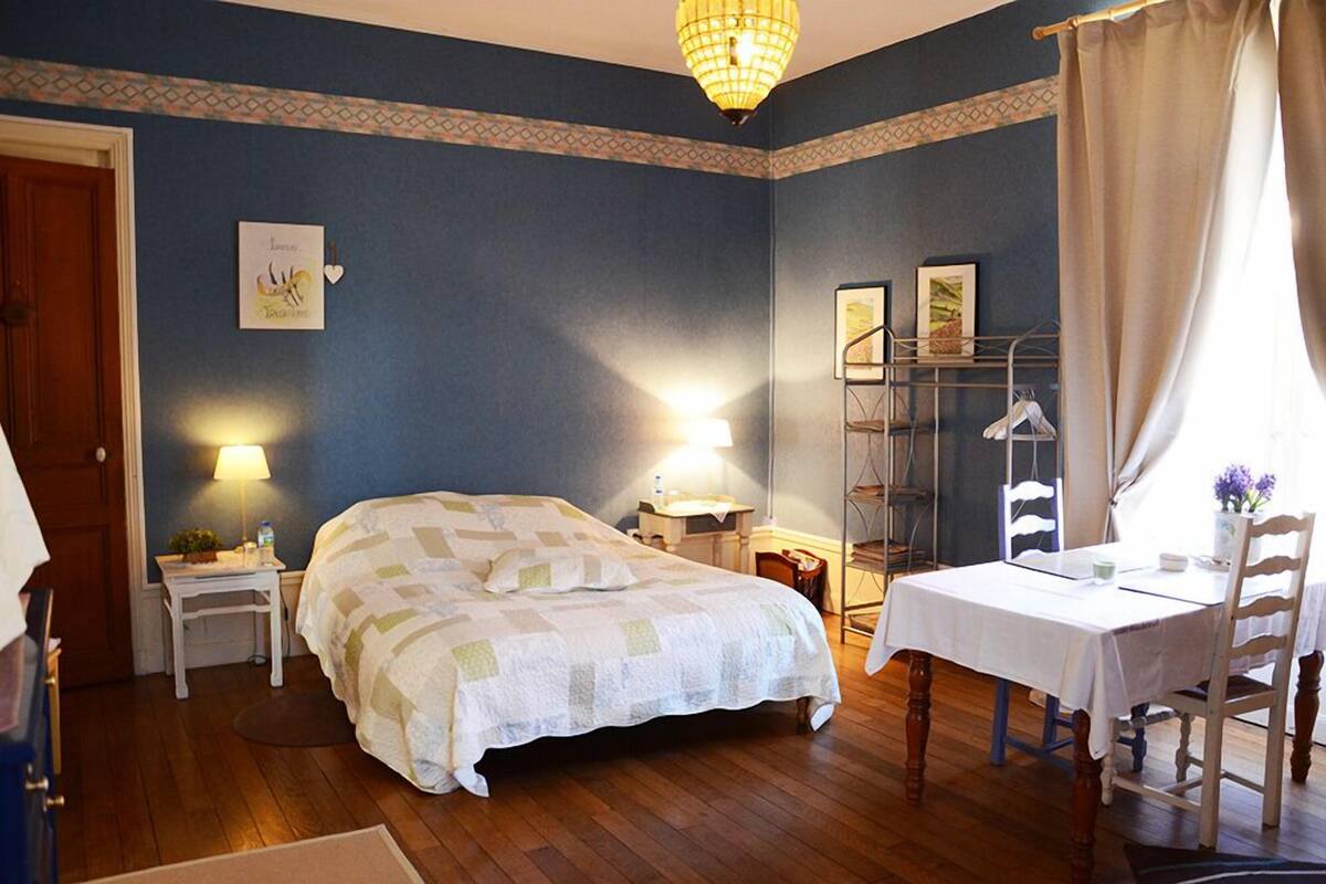 Ein Schlafzimmer mit Bett, Nachttischen, Schreibtisch und Stuhl.