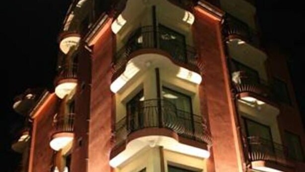 A multi-story hotel with balconies and illuminated windows. - Hotel Sofia (Pomorie)