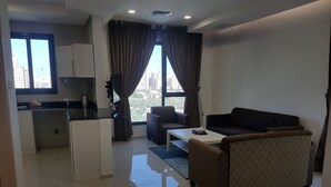 A modern apartment with a kitchen, dining area, and living room. - Magic Suite Boulevard Salmiya (Salmiya)