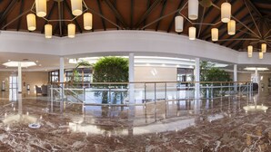 A spacious lobby with a marble floor, a reception desk, and a staircase leading to upper levels. - Sagitario Princesa Playa (Ciutadella de Menorca)