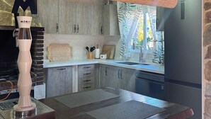 A kitchen with a stone wall, a wooden countertop, a Morit coffee maker, and a sign reading 'Punta Cana.' - Owner Joan Andreu Calvet Fosch, Luxury villa with private pool. (Alcanar Playa)