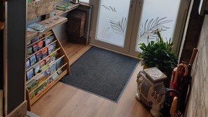 A reception area with a wooden desk, a map display, and a door with frosted glass panels.