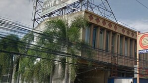A building with a sign indicating it's open 24 hours.