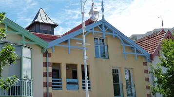 A building with a distinctive architectural style, featuring a peaked roof and a lantern post.