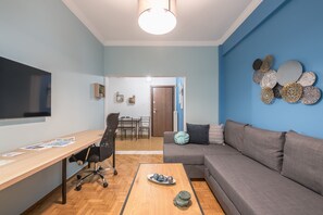 Departamento empresarial, 1 habitación | Área de sala de estar | Televisión de pantalla plana 