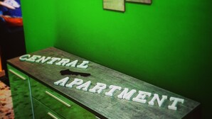 A green wall with a sign reading "CENTRAL APARTMENT" and a series of framed pictures depicting beach scenes. - Central Isernia (Isernia)