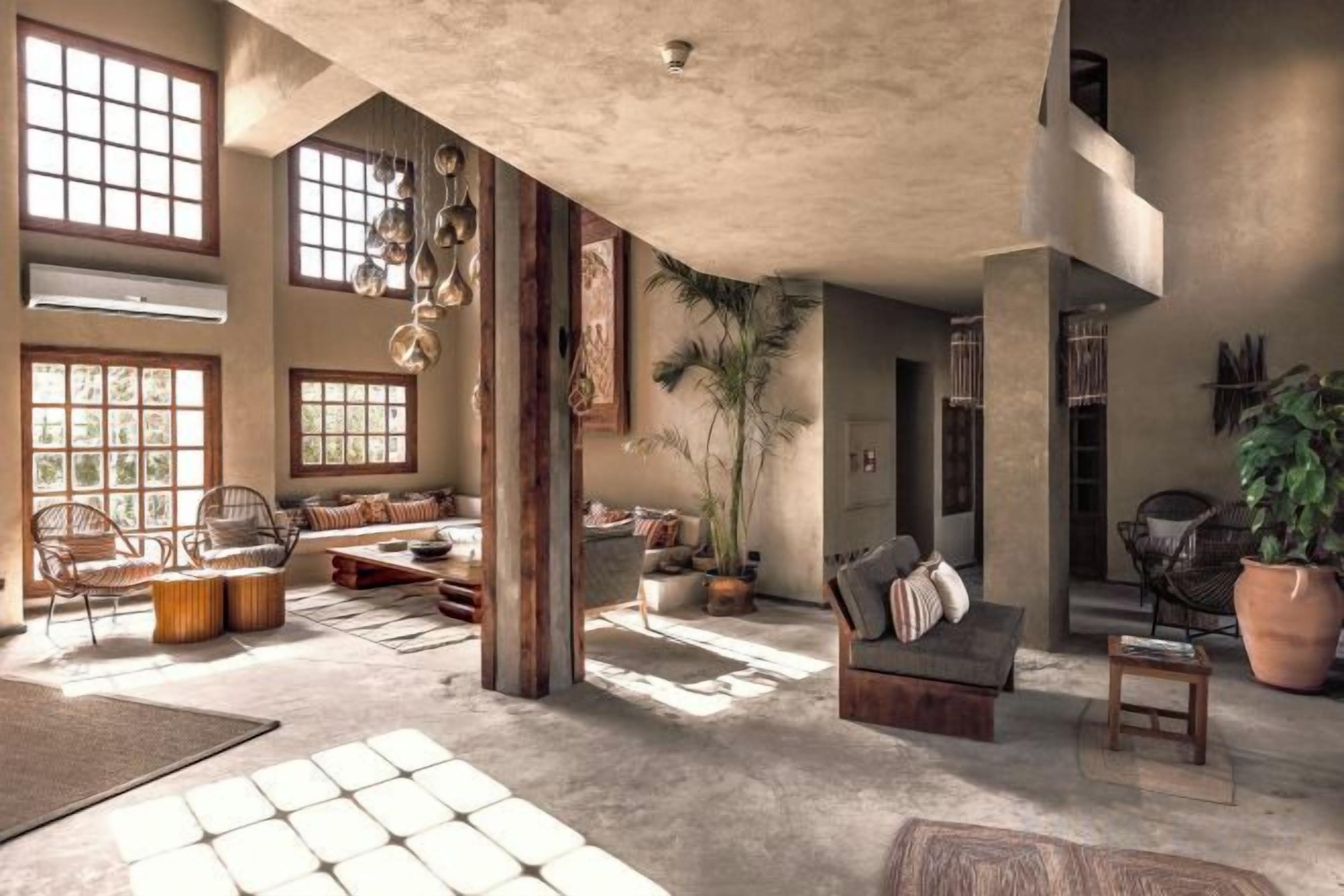 Amplia sala de estar con ventanas grandes, techo alto y una variedad de opciones de asientos, incluyendo sofás y sillones.
