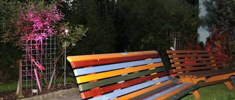 A bench with a grid-like structure behind it.