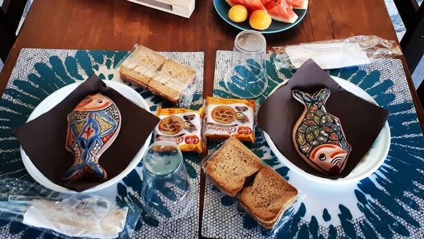 A wooden table set with various breakfast items including bread, fruits, condiments, and beverages. - Cozzo Spadaro B&B (Pachino)