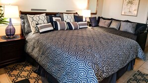 A neatly arranged bedroom with a large bed, two bedside tables, and a nightstand. - Boardwalk 932 (Myrtle Beach)