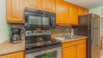 Stovetop, coffee/tea maker, cookware/dishes/utensils, dining tables