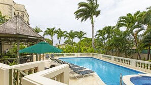 A swimming pool with lounge chairs and a gazebo. - Blue Haven (Bowling Alley Hill)