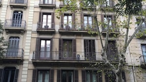 A multi-story building with balconies and large windows. - Hostal Goya (Barcelona)