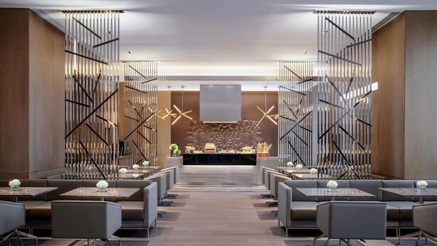 A modern hotel lobby with a central reception desk, seating areas, and decorative lighting. - Courtyard by Marriott Shanghai Minhang (Shanghai)