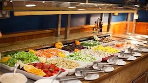 A buffet with various food options including salads, fruits, and other dishes. - Bella Vista (Blue Ridge)