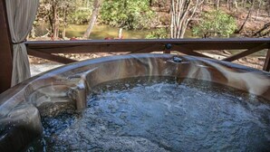 A hot tub with a view of a natural landscape.