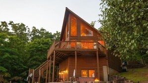 A wooden cabin with a balcony, a fire pit, and a satellite dish. - Panoramic Paradise (Morganton)