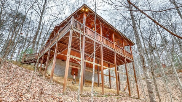 A wooden cabin with a balcony, surrounded by trees. - The Bella Rose Retreat (Blue Ridge)