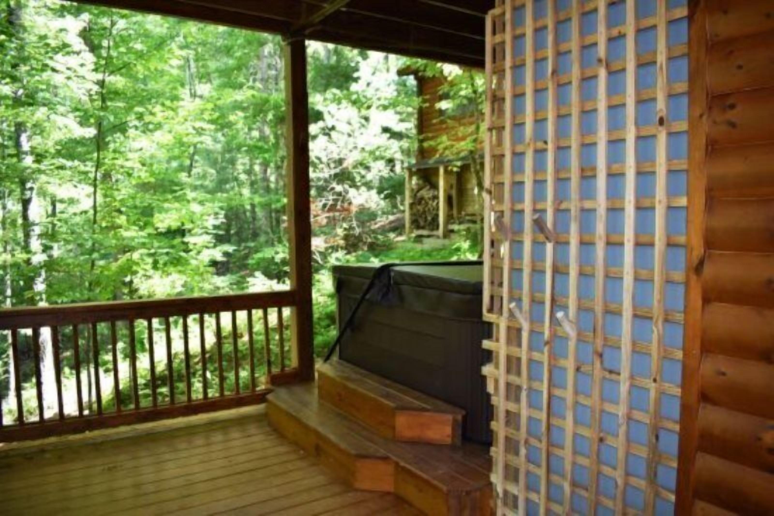 A wooden deck with a view of a forest.