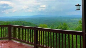 A wooden deck with a railing overlooking a mountainous landscape. - Longview (Blue Ridge)