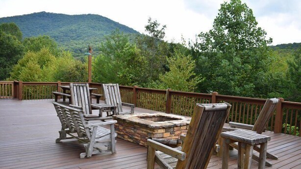 A wooden deck with Adirondack chairs and a stone fire pit. - Golden Mountain Top (Suches)