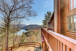 A wooden cabin with a balcony overlooking a lake and forested hills. - Under The Stars (Blue Ridge)