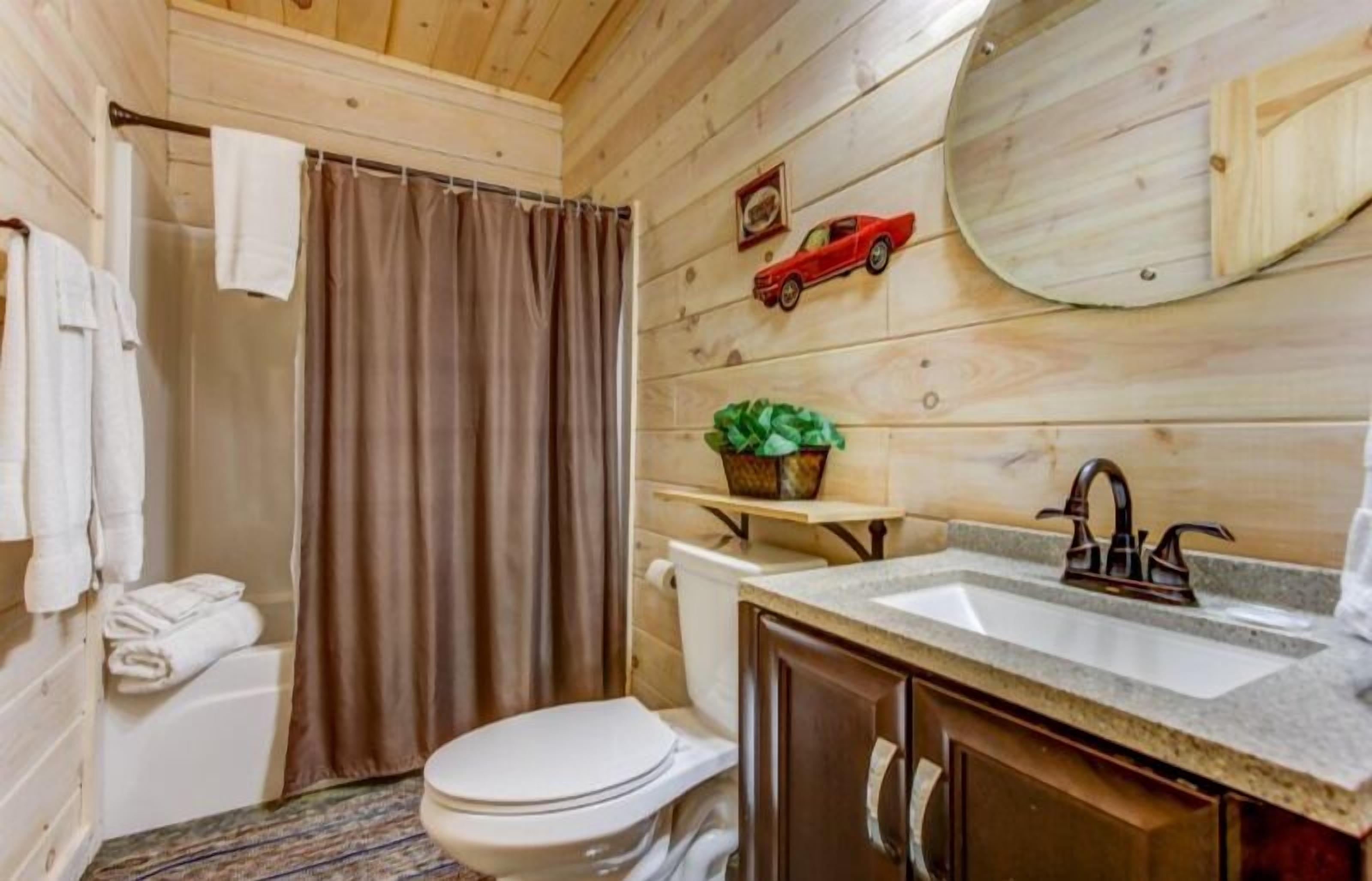 Un baño pequeño con inodoro, lavabo y cortina de ducha.