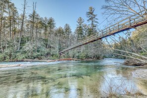 A wooden bridge over a river surrounded by trees. - Lonesome Dove (Blue Ridge)