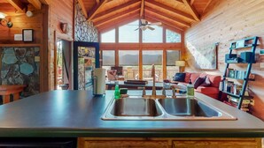 A kitchen with a large island, double sinks, and a stone accent wall. - Twin Peaks 2/malu (Blue Ridge)