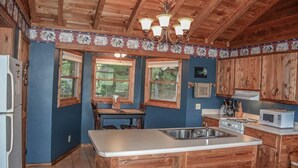 A kitchen with wooden cabinets, a white countertop, and a built-in sink. - Okeana (Blue Ridge)