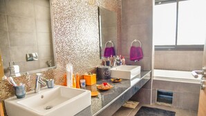 A modern bathroom with two sinks, a large mirror, and a bathtub. - GREAT VILLA OF NATIONS (BOUKNADEL)
