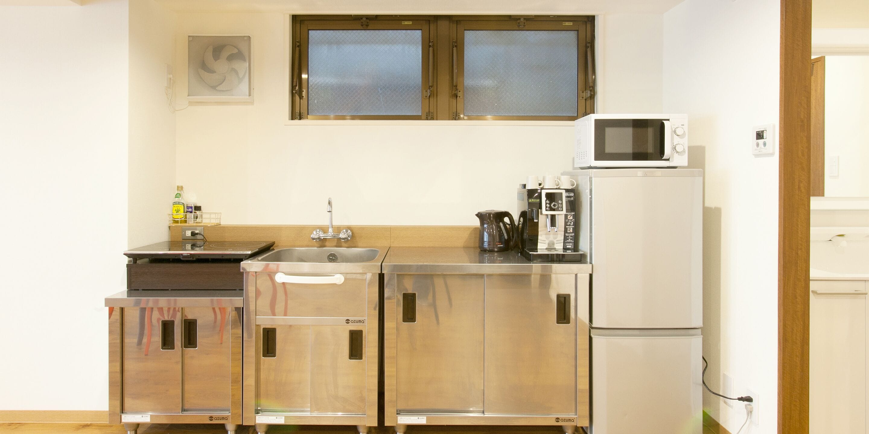 A compact kitchen with a sink, a microwave, and a refrigerator.
