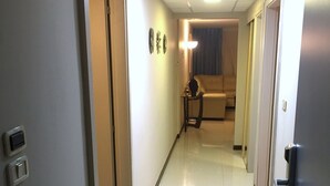A hotel hallway with a sofa and a lamp in the background. - DISCOUNTED Royal Islander Club 2 Bdrm Suite, Sleeps 6, Wifi, Pool, - MAHO BEACH! (Maho Bay)