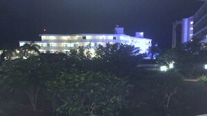A multi-story building with illuminated windows and a flat roof. - DISCOUNTED Royal Islander Club 2 Bdrm Suite, Sleeps 6, Wifi, Pool, - MAHO BEACH! (Maho Bay)