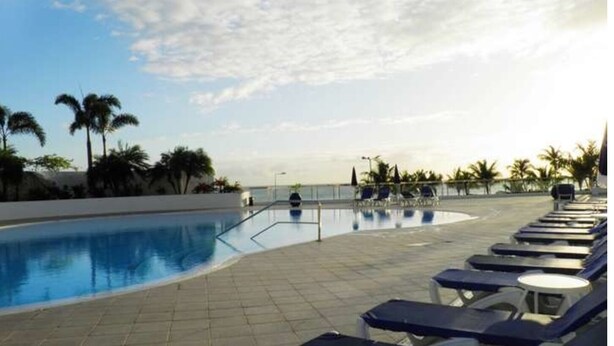 A pool area with lounge chairs and palm trees. - DISCOUNTED Royal Islander Club 2 Bdrm Suite, Sleeps 6, Wifi, Pool, - MAHO BEACH! (Maho Bay)
