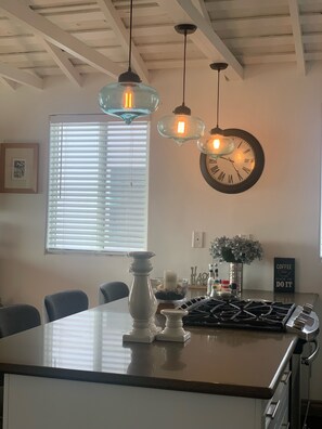 Enjoy cooking in this well-equipped kitchen with a central island and modern stove.