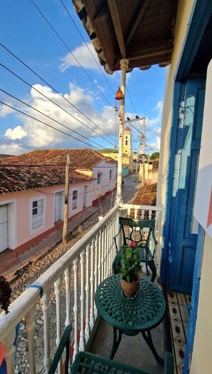 Enjoy a tranquil balcony with a view of a traditional building and its iconic bell tower.