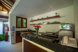 A modern kitchen with a central island, built-in appliances, and a water dispenser.