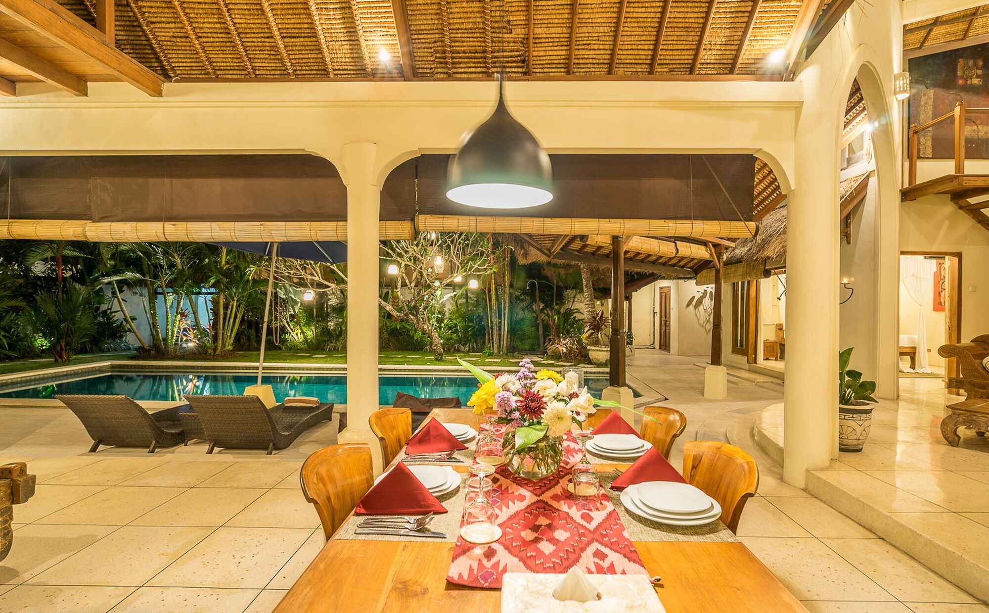 An indoor pool area with a dining setup.