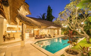 A resort with a swimming pool, outdoor seating, and a thatched-roof structure. - Best Location! 3BD Villa, Central Seminyak! - 3Min Walk To Eat Street! W/Pool! (seminyak)