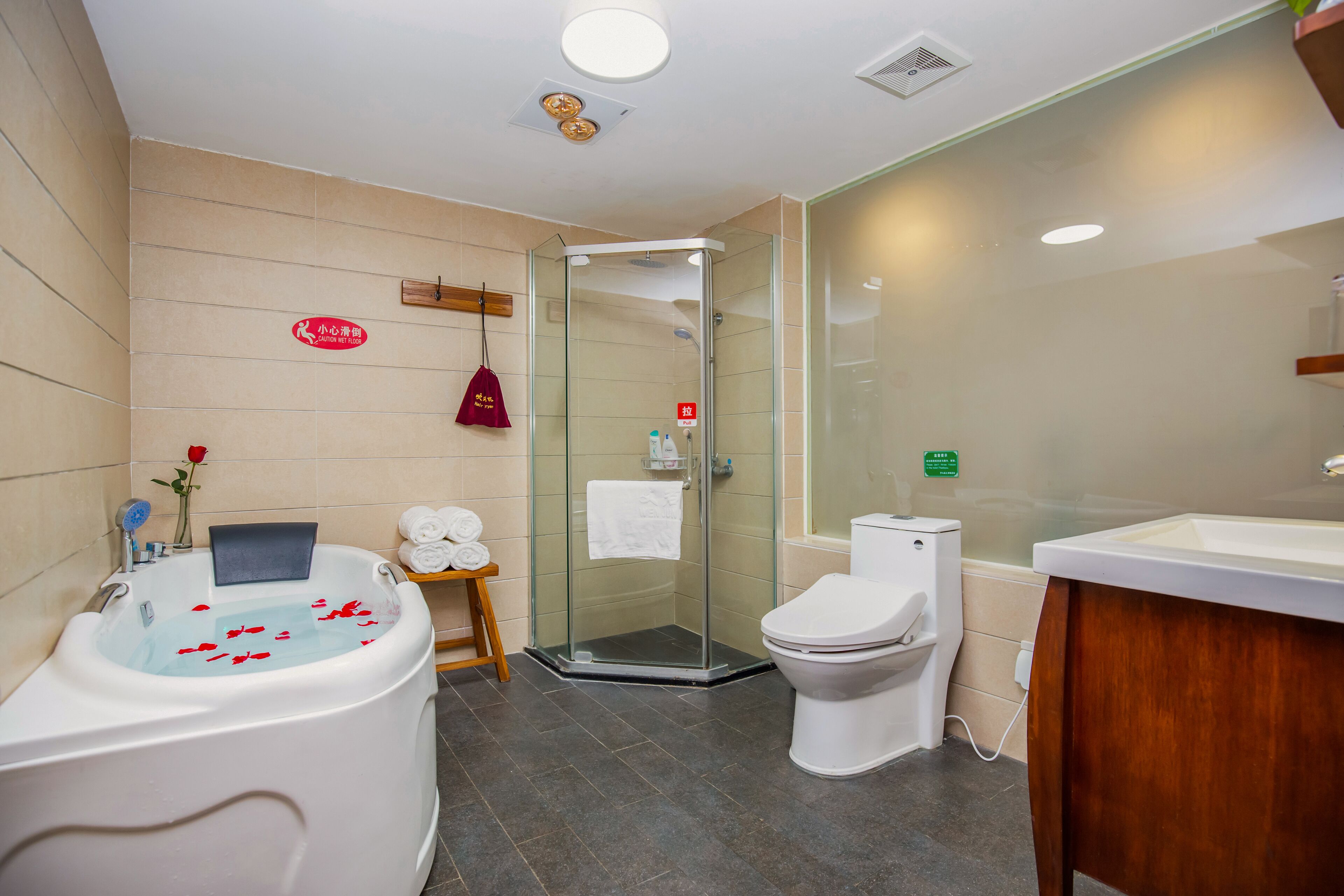 deluxe family suite | bathroom | designer toiletries, hair dryer, slippers, towels