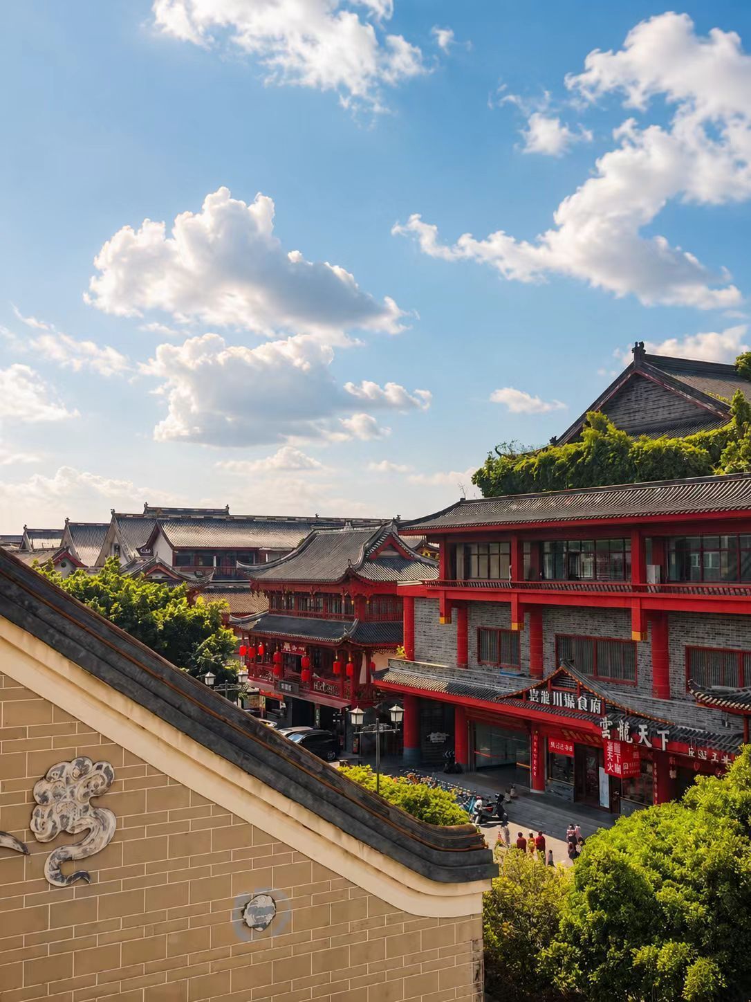 A traditional building with a red facade and multiple levels, featuring a mix of traditional and modern architectural elements.