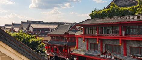 A traditional building with a red facade and multiple levels, featuring a mix of traditional and modern architectural elements.
