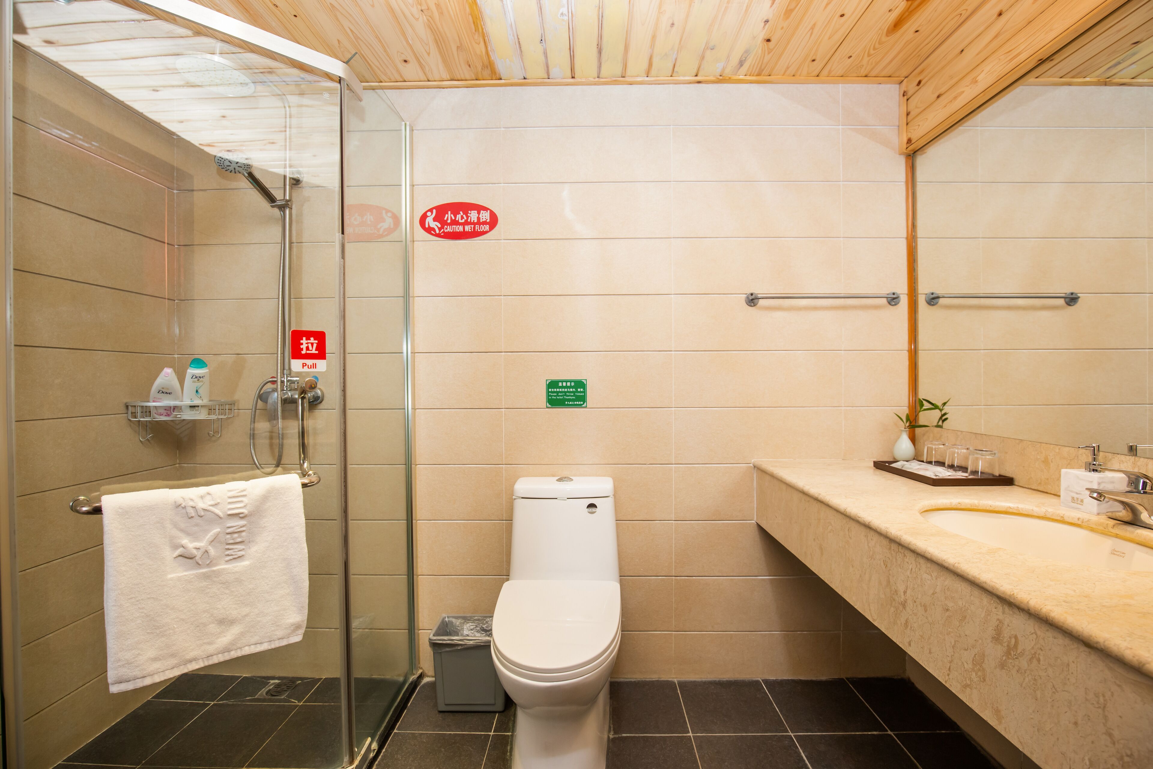 designer toiletries, hair dryer, slippers, towels